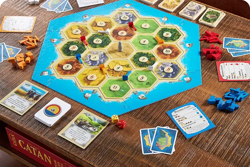 Il gioco da tavolo "I Coloni di Catan", con tessere esagonali delle risorse, pedine dei giocatori e carte, pronto per una partita strategica da tavolo con gli amici.
